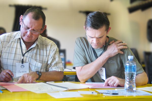 A mine manager and contractor work on establishing a common understanding of Project Management challenges during an intensive workshop in Midrand, Gauteng.